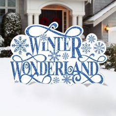 a sign that says winter wonderland in front of a house with snowflakes on it