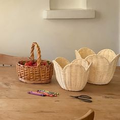 wicker baskets and crayons sit on a wooden table