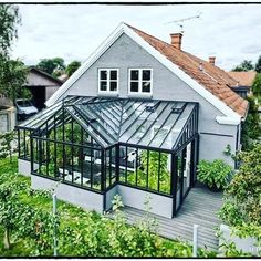 a house with a glass roof in the yard