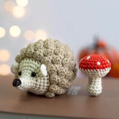 a crocheted hedge and mushroom sitting on top of a wooden table next to each other