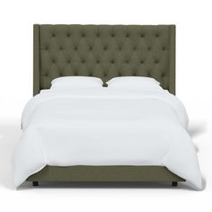 a bed with a green headboard and white sheets on it's sides, in front of a white background