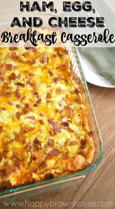 ham, egg and cheese breakfast casserole in a glass dish on a wooden table