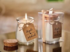 two glass jars with labels on them sitting on a table