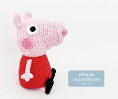 a crocheted pig sitting on top of a white surface