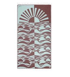 a brown and white towel with waves on it, the sun is shining over the water