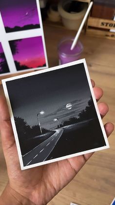 a person holding up a polaroid in their hand