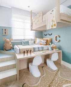 a child's bedroom with blue walls and white furniture, including a bunk bed