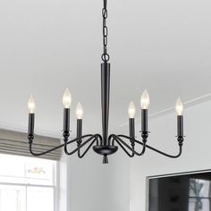 a black chandelier with five lights hanging from it's center and four arms