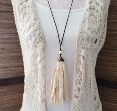 This tassel necklace is made from cream colored Sari Silk ribbon.  What I love about the Sari Silk ribbon that I used here is that it made from silk scraps that poor women in India gather from factory floors. They then sew them together to sell to support their families. There is a glass pearl on the top of the tassel. This necklace comes on a 30 inch brass chain (if you would like a shorter or longer chain just make a note on your order. I will replace it for you).  Earrings coordinating with this necklace are available here: https://www.etsy.com/listing/776946161/tassel-earrings-silk-sari-silk-dangle This necklace comes packaged in an organza gift bag with the story of The Broken Shell* and the information that all proceeds from this sale will be used by Huruma Ministries to minister to Sari Silk, Inner Beauty, Organza Gift Bags, How To Make Notes, Silk Ribbon, Brass Chain, Tassel Earrings, Silk Fabric, Cream Color