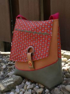 a purse sitting on top of a pile of rocks