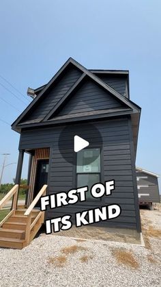 a small black house with the words first of its kind on it's side