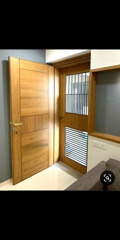 a room with a bed and a wooden door that has blinds on the window sill