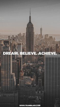 the words dream believe achieve above a cityscape with skyscrapers in the background