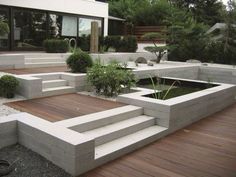 an outdoor garden with concrete steps and plants