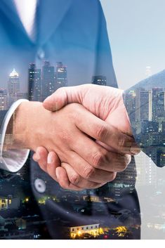 two men shaking hands in front of a cityscape