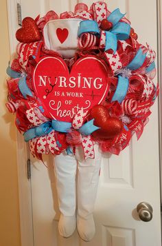 a wreath that says nursing is a work of heart surrounded by red, white and blue hearts