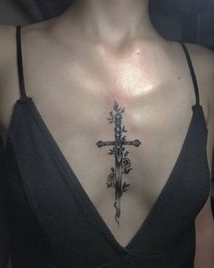 a woman with a cross tattoo on her chest