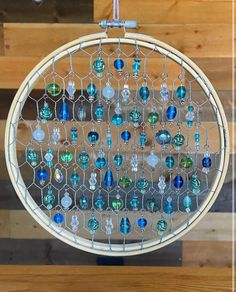 a close up of a circular object with many different colored glass beads hanging from it