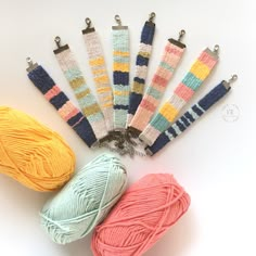 several skeins of yarn are arranged next to each other on a white surface