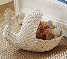 a wicker basket filled with toys on the floor