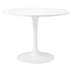 a white table with an oval top on a white background in front of a white backdrop