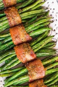 asparagus wrapped in bacon on a white plate