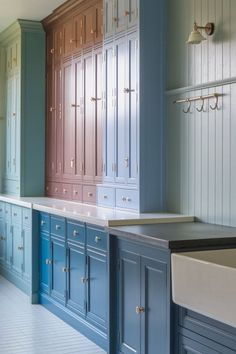 Blue distressed kitchen cabinets with brass hardware, light wood floors, and a cozy, cottage-inspired design. #KitchenCabinets #CounterTops #TheKitchen #SmallKitchenWithLightWoodFloors Blue Kitchen Cabinets, Light Wood Floors