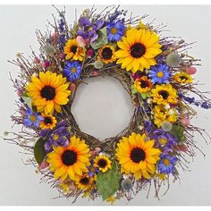 a wreath with sunflowers and purple flowers