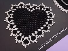 a black and white doily with the words gift box included