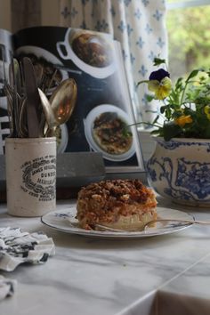 a piece of pie sitting on top of a plate next to a potted plant