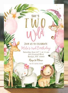 an animal themed birthday party with pink and gold foil on the top, including giraffes