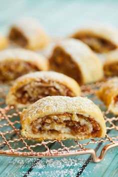 several pastries on a wire rack with powdered sugar