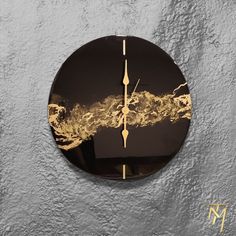 a clock that is on the side of a wall with some gold paint in it