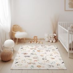 a baby's room with white walls and wooden flooring is decorated in neutral colors