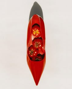 a woman's red shoe with flowers on the inside and bottom, viewed from above