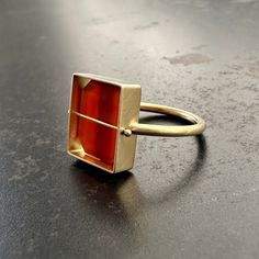 This vintage, octagonal carnelian tile with a vivid orange tone is uniquely Captured in 18k gold. Elegantly geometric, this ring has a classically modern feel with Hilary's signature Captured setting. 18k gold, carnelian. Made to order and will ship in 2-3 weeks. Modern Carnelian Jewelry With Polished Finish, Modern Carnelian Jewelry For Formal Occasions, Modern Carnelian Gemstone Jewelry, Orange Tone, Carnelian Ring, Orange Tones, Brand Image, 3 Weeks, 18k Gold