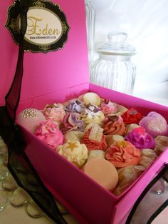 a pink box filled with lots of different colored soaps