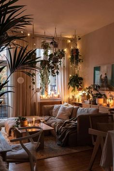 a living room filled with furniture and lots of plants