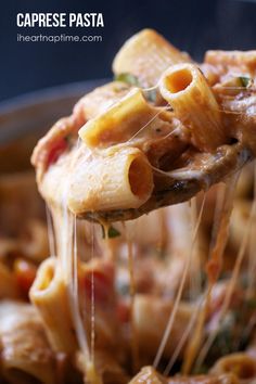 a spoon full of pasta being lifted from a skillet with the words caprese pasta on it