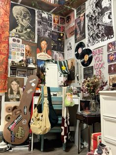 a room filled with lots of posters and guitars