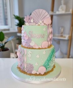 two tiered cake decorated with sea shells and seashells