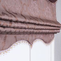 a close up of a curtain with beads hanging on it's rodulage