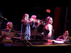 a group of people playing instruments on stage