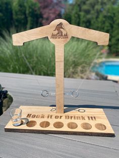 a wooden trophy with an image of a man's shirt on it and two shot glasses