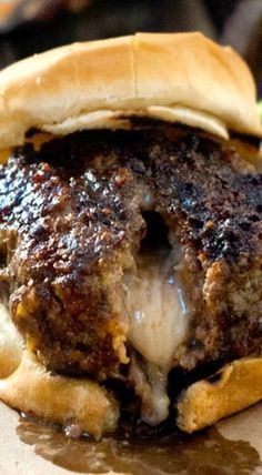 a close up of a hamburger on a plate