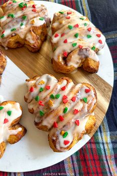 several pastries are sitting on a plate with icing and sprinkles