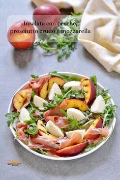 a salad with peaches, prosciutto and mozzarella in a white bowl