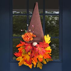 a fall wreath with a gnome's hat on it