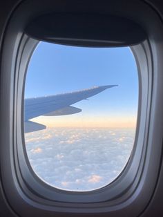 an airplane window looking out at the clouds