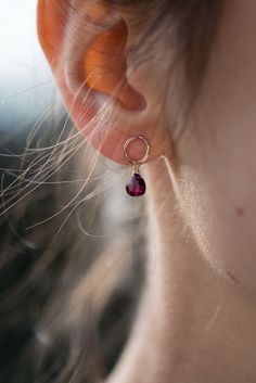 Exquisitely dainty 14k gold-filled earring studs with a rhodolite garnet briolette drop - little love drops for the ears. Elevate your elegance with our delicately handcrafted garnet drop earrings. A 14k gold-filled stud hosts a petite rhodolite garnet faceted briolette that gracefully catches light and moves as you do, adding an exquisite touch. These earrings are more than accessories; they're memories. Perfect for bridesmaids, they symbolize cherished moments. For mom, they express gratitude. For a girlfriend, they speak of affection. And for a wife, they echo love. Crafted to be a simple yet remarkable everyday accessory, these earrings effortlessly transform any look into something delicate and special. Whether as a personal indulgence or a thoughtful gift, these earrings offer a touc Luxury Briolette Pearl Earrings Elegant, Garnet Drop Earrings, Drop Earrings Gold, Express Gratitude, Tiny Earrings, Red Gemstones, Earring Studs, Garnet Earrings, Rhodolite Garnet